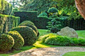 THE OLD RECTORY, QUINTON, NORTHAMPTONSHIRE: DESIGNER ANOUSHKA FEILER: FRONT GARDEN - LAWN, CLIPPED TOPIARY YEW BALLS, HEDGE. HEDGES, HEDGING, GREEN, TAXUS, ROCK, HAKONECHLOA MACRA