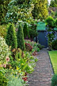 COTTAGE ROW, DORSET: STONE PATH, CLIPPED YEW TOPIARY, BORDER, CLASSIC, COUNTRY, GARDEN, GREEN