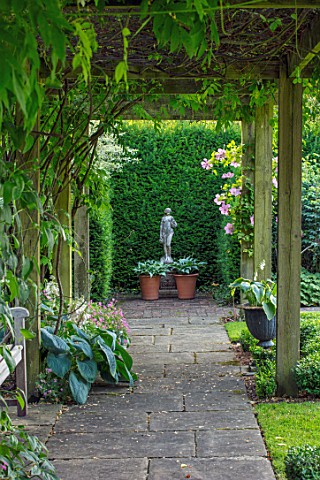 COTTAGE_ROW_DORSET_PATH_WOODEN_PERGOLA_HOSTAS_IN_CONTAINERS_STATUE_FORMAL_ENGLISH_CLASSIC_GARDEN_FRA