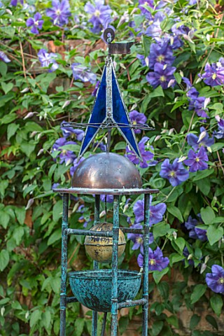 WOLLERTON_OLD_HALL_SHROPSHIRE_CLEMATIS_AND_OLD_COPPER_PIPE_ORNAMENT