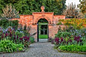 MORTON HALL GARDENS, WORCESTERSHIRE: KITCHEN GARDEN IN LATE SUMMER. BEDS WITH AMARANTHUS, GATE, WALL, WALLED, COUNTRY, HOUSE, CLASSIC, VEGETABLE, ARCH