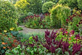 MORTON HALL GARDENS, WORCESTERSHIRE: KITCHEN GARDEN IN LATE SUMMER. BEDS WITH AMARANTHUS, ZINNIAS. WALL, WALLED, COUNTRY, HOUSE, CLASSIC, VEGETABLE, DARK, RED, DAHLIAS