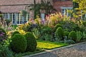 MORTON HALL, WORCESTERSHIRE: SOUTH GARDEN, BORDER, LAWN, CLIPPED BOX, CLEOME SPINOSA VIOLET QUEEN, PEROVSKIA BLUE SPIRE. SUMMER, FLOWERS, ENGLISH