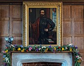 BADDESLEY CLINTON, WARWICKSHIRE: THE NATIONAL TRUST- CHRISTMAS, 15TH AND 16TH CENTURY MOATED MANOR HOUSE. STONE MANTELPIECE DECORATED WITH DRIED FLOWER GARLAND