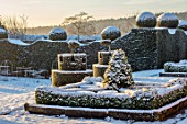 FELLEY PRIORY, NOTTINGHAMSHIRE: WINTER - SNOW. CLIPPED, TOPIARY, HEDGES, HEDGING, YEW CASTLES, FLAGS, DECEMBER, TAXUS, DAWN, SUNRISE, PARTERRE, BOX