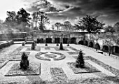ABERGLASNEY GARDENS, CAMARTHENSHIRE, WALES. CLOISTER GARDEN IN SNOW. FEBRUARY, KNOT, KNOTS, PARTERRE, GRASS, FORMAL ,TRIMMED SHAPES, BLACK AND WHITE