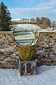 ABERGLASNEY GARDENS, CAMARTHENSHIRE, WALES. PARAPET WALK IN SNOW, FEBRUARY, LEAD CONTAINERS, TOPIARY, CLIPPED, BOX, BUXUS