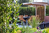 ASCOT SPRING GARDEN SHOW: DESIGNER TOM HILL. COURTYARD, DINING AREA, CANOPY, TABLE, CHAIRS, WATER FEATURE, ENCLOSED, PRIVATE, SCREENS, SCREENING, SCREENED, SMALL, TOWN, URBAN