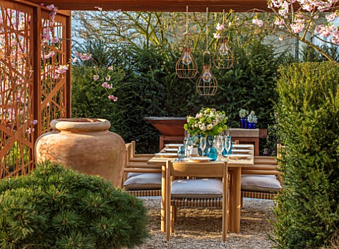 ASCOT_SPRING_GARDEN_SHOW_GARDEN_DESIGNED_BY_KATE_GOULD_TABLE_CHAIRS_TERRACOTTA_CONTAINER_CORTEN_STEE