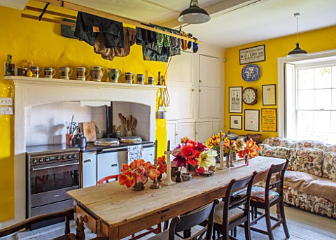 THE_OLD_PARSONAGE_LITTLE_BREDY_DORSET_THE_KITCHEN_WITH_DINING_TABLE_AND_CHAIRS_SOFA_RANGE_COOKER_TUL