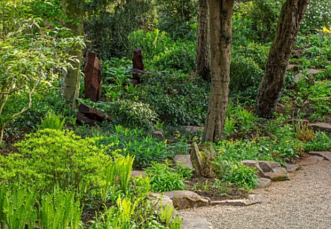 MORTON_HALL_WORCESTERSHIRE_THE_ROCKERY__SHADE_SHADY_GREEN_FOLIAGE_GRAVEL_WOOD_SCULPTURE_FROM_FELLED_