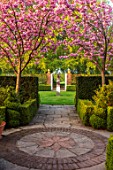 MITTON MANOR, STAFFORDSHIRE: PATH, TERRACOTTA CONTAINER, STEPS, CHERRY BLOSSOM, OBELISK, CLIPPED, TOPIARY, SPRING, PRUNUS, BLOSSOM, PINK, FLOWERS, SYMMETRY