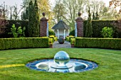 MITTON MANOR, STAFFORDSHIRE: PATH, TOPIARY, AVENUE, FORMAL, COUNTRY, BOX, TOPIARY, HEDGES, HEDGING, EVERGREEN, SPRING, SUMMERHOUSES, POND, POOL, LAWN, CIRCULAR, GLASS WATER FEATURE