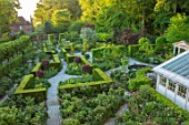 CLAUS DALBY GARDEN, DENMARK: PATHS AND GARDEN ROOMS SEEN FROM THE HOUSE, YEW HEDGES, HEDGING, SPRING, CONSERVATORY, GREENHOUSE