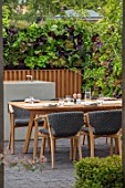 CHELSEA FLOWER SHOW 2018: URBAN FLOW GARDEN, DESIGNER TONY WOODS. TABLE, CHAIRS, PATIO, LIVING WALL, KITCHEN, DINING AREA, ENTERTAINING, SALAD, CROPS, COOKING, COOKERY