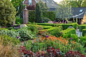 MITTON MANOR, STAFFORDSHIRE:FORMAL GARDEN PARTERRE WITH EMPTY TERRACOTTA CONTAINERS AND BOX EDGED BEDS. HEDGES, HEDGING, SPRING, ALLIUM PURPLE SENSATION, HEUCHERAS AND POTENTILLA