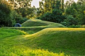 ASTHALL MANOR, OXFORDSHIRE: TURF MOUNDS, SUNSET, LAWN, HILL, HILLS, VIEWING MOUND, GREEN, GRASS