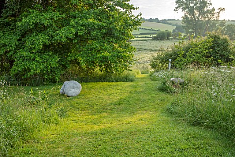 ASTHALL_MANOR_OXFORDSHIRE_STEPS_LAWN_MEADOW_COUNTRYSIDE_BEYOND_ENGLISH_COUNTRY_GARDEN_SUMMER