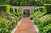 WORMSLEY, BUCKINGHAMSHIRE: FLINT AND BRICK PATH THROUGH THE WALLED GARDEN - BORDER WITH PERENNIALS, SUMMER, ENGLISH, COUNTRY, GARDEN, WALLS, WALLED, YEW HEDGES, HEDGING