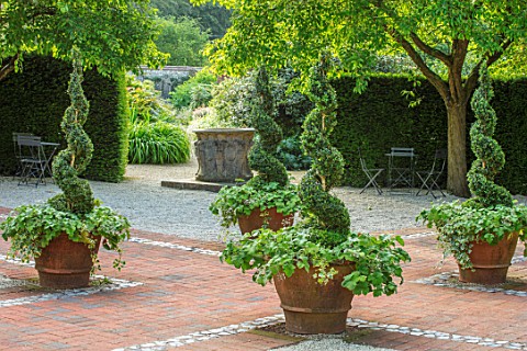 WORMSLEY_BUCKINGHAMSHIRE_FLINT_AND_BRICK_PATH_WALLED_GARDEN__TERRACOTTA_CONTAINERS_BOX_SPIRALS_MALUS
