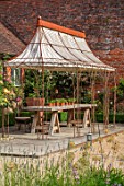 THE WALLED GARDEN AT COWDRAY, WEST SUSSEX: SEATING AREA WITH RUSTY METAL PERGOLA, AWNING, PLACE TO SIT, DINING, AL FRESCO, ENTERTAINING