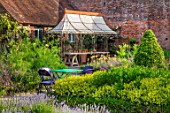 THE WALLED GARDEN AT COWDRAY, WEST SUSSEX: OUTDOOR DINING, SEATING AREA WITH RUSTY METAL PERGOLA, AWNING, PLACE TO SIT, DINING, AL FRESCO, ENTERTAINING