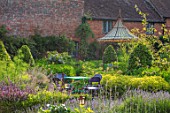 THE WALLED GARDEN AT COWDRAY, WEST SUSSEX: OUTDOOR DINING, SEATING AREA TABLE, CHAIRS, BOX PARTERRES, GREEN, ENGLISH, COUNTRY, GARDEN, AWNING, GAZEBO