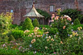 THE WALLED GARDEN AT COWDRAY, WEST SUSSEX: BORDERS, ROSES, OUTDOOR DINING, SEATING AREA TABLE, CHAIRS, BOX PARTERRES, GREEN, ENGLISH, COUNTRY, GARDEN, AWNING, GAZEBO, AL FRESCO