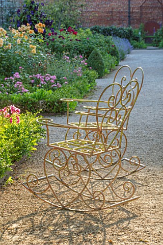 THE_WALLED_GARDEN_AT_COWDRAY_WEST_SUSSEX_GRAVEL_PATH_METAL_CHAIRS_SEATING_SUMMER_BORDERS_BOX_EDGED_B