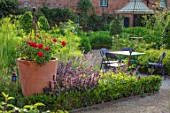 THE WALLED GARDEN AT COWDRAY, WEST SUSSEX: ENGLISH, COUNTRY, GARDEN, BOX EDGED, BORDERS, CONTAINER, ROSES, TABLE, CHAIRS, SEATING, PATHS, SUMMER, ROSA FOR YOUR EYES ONLY