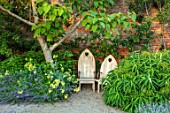 THE WALLED GARDEN AT COWDRAY, WEST SUSSEX: PLACE TO SIT, CATALPA, WOODEN BENCH, SEAT, SHADE, SHADY