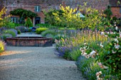 THE WALLED GARDEN AT COWDRAY, WEST SUSSEX: PATH, BORDERS WITH LAVENDER, VERBENA BONARIENSIS, BRICK RAISED POND, POOL, WATER FEATURE, ENGLISH, COUNTRY, GARDENS, SUMMER