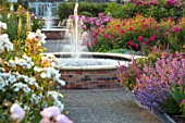 WYNYARD HALL, COUNTY DURHAM: WALLED ROSE GARDEN. GRAVEL PATH, FOUNTAIN, RAISED, ROSES, FLOWERS, SUMMER, JUNE, RAISED BEDS, WATER
