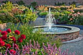 WYNYARD HALL, COUNTY DURHAM: WALLED ROSE GARDEN. GRAVEL PATH, FOUNTAIN, RAISED, ROSES, FLOWERS, SUMMER, JUNE, RAISED BEDS, WATER