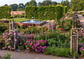 WYNYARD HALL, COUNTY DURHAM: WALLED ROSE GARDEN. ROSES, FLOWERS, SUMMER, JUNE BEDS. WOODEN, TRELLIS, SUPPORTS, CLIMBERS, WALLS, FOUNTAIN, WATER FEATURE, POOL, PLEACHED TREES
