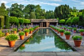 HAMPTON COURT CASTLE, HEREFORDSHIRE: THE DUTCH GARDEN - TERRACOTTA CONTAINERS OF BLUE AGAPANTHUS BESIDE CANAL, POND, POOL, WATER, SUMMER, BULBS, JULY, BUILDINGS, SUMMERHOUSES