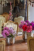PYTTS HOUSE, OXFORDSHIRE: THE DINING ROOM. DINING TABLE, CHAIRS, CANDELABRAS, MIRROR, PINK FLOWERS OF PHLOX IN SILVER CONTAINERS