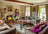 PYTTS HOUSE, OXFORDSHIRE: SITTING ROOM, SOFAS, CUSHIONS, FIREPLACE