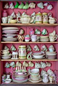 PYTTS HOUSE, OXFORDSHIRE: CABINET IN KITCHEN PAINTED PINK WITH CROCKERY