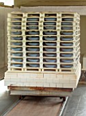 ALHAM FARM, SOMERSET: CORNISHWARE: THE POTTERY - CORNISHWARE BLUE AND WHITE STRIPED BOWLS COMING OUT OF THE KILN
