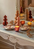 PYTTS HOUSE, OXFORDSHIRE: CLASSIC BEDROOM, GOLD, BURNT ORANGE: TABLE, CHRISTMAS, CANDLES, PAPER DECORATIONS, MIRROR, CUPS AND SAUCERS