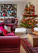 GIBBONS CROFT, WEST CLANDON, SURREY: CHRISTMAS - SITTING ROOM, RED SOFAS, PAINTING BY FAMILY FRIEND, CHRISTMAS TREE
