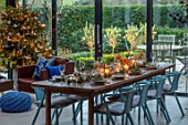 GIBBONS CROFT, WEST CLANDON, SURREY: CHRISTMAS. OPEN PLAN KITCHEN, DINING ROOM. GLASS WALLED EXTENSION, FIREPLACE, WOODEN DINING TABLE, CHAIRS, CHRISTMAS TREE