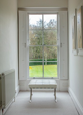 GIBBONS_CROFT_WEST_CLANDON_SURREY_UPPER_HALL_VIEW_ONTO_GARDEN_SASH_WINDOW_WHITE_LEATHER_AND_CHROME_F