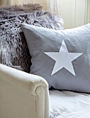 AMANDA KNOX HOUSE GRANTHAM: CHRISTMAS, LIVING ROOM - GREY CUSHION WITH WHITE STAR ON LOUNGER