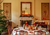 MARBURY HALL, SHROPSHIRE: DESIGNER SOFIE PATON-SMITH - TAPESTRY DINING ROOM, SWEDISH CHRISTMAS - LUNCH SERVED IN HOME MADE STRAW BASKET , CANDLES