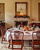 MARBURY HALL, SHROPSHIRE: DESIGNER SOFIE PATON-SMITH - TAPESTRY DINING ROOM, SWEDISH CHRISTMAS - LUNCH SERVED IN HOME MADE STRAW BASKET , CANDLES, MIRROR