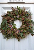 MERRYWOOD, JACKY HOBBS HOUSE, LONDON: NATURAL DOOR WREATH AND GARLAND. CONES, SEEDS, DECORATIONS, PEACOCK FEATHERS