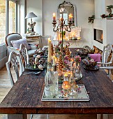 MERRYWOOD, JACKY HOBBS HOUSE, LONDON: SITTING ROOM - DINING AREA, WOODEN DINING TABLE AND CHAIRS, MIRRORS, CANDLES, METAL CROWNS