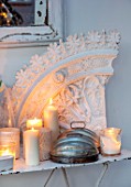 MERRYWOOD, JACKY HOBBS HOUSE, LONDON: DINING ROOM - VINTAGE FRENCH METAL GARDEN TABLE, VINTAGE PLASTER ARTEFACTS, WHITE CANDLES, METAL DECORATIVE DOME